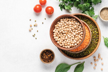 Bowls with chickpeas, lentils, mung peas, green parsley and spinach. Vegan healthy winter seasonal cooking