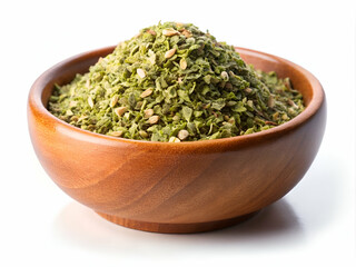 A bowl of green herbs and spices sits on a white background. The bowl is wooden and filled with a variety of herbs and spices