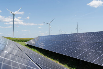 Solar panels and wind turbines on a field. Sustainable energy