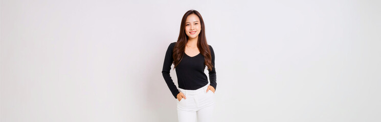 A portrait of a Southeast Asian woman wearing a black long-sleeve T-shirt and white skinny pants.