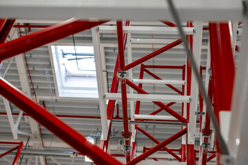 Close up photograph of sprinkler system head inside racking system of manufacturing plant