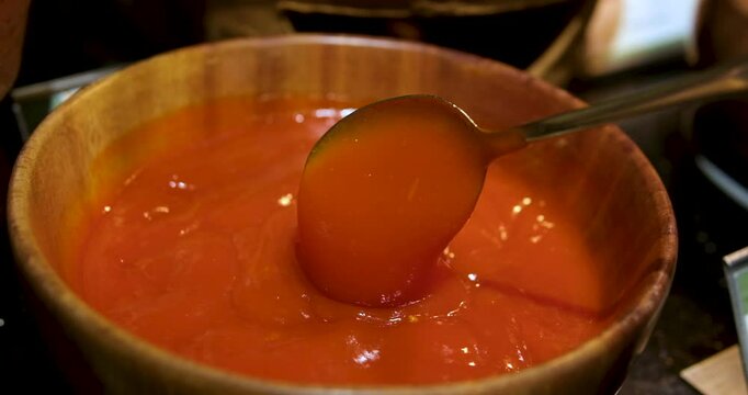 scoop sauce with a spoon buffet in a restaurant close-up ketchup scoop with a large tablespoon