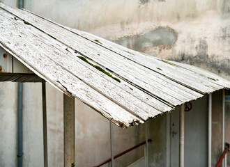 A fragment of the collapsing roof of a street canopy made of plastic PVC panels