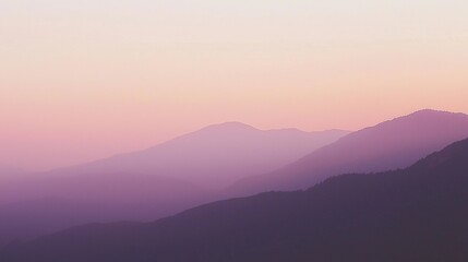 Obraz premium Mesmerizing view of mountain ranges fading into the distance as the sun sets, creating a gradient of pink and purple hues