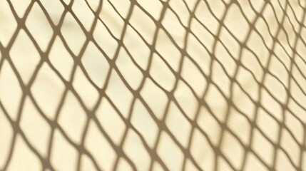 Naklejka premium Light shines through a net, creating mesmerizing shadows on a smooth surface with geometric patterns