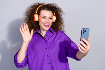 Photo of nice young woman arm wave hi selfie smart phone wear purple shirt isolated on grey color background