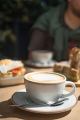 Latte, accompanied by toasted bread with tomato, avocado and egg. Photo of breakfast for an institution, Delicious food. Culinary concept.