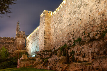 Fototapeta premium View of the Tower of David and western expanse of walls and ramparts of the Old City at twilight in Jerusalem. .