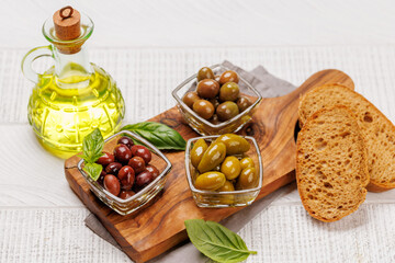 An assortment of various olives presented in a bowl, showcasing different colors, textures, and flavors