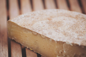 Craft cheese for sale at a farmer's market. Crafted Cheese on Wooden Background. closeup of piece of italian parmesan cheese. 