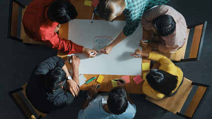 Top down view of business team working together by using mind map brainstorming idea and sharing...