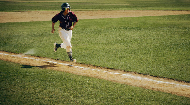 Base runner in action during a professional baseball game on a bright, sunny afternoon