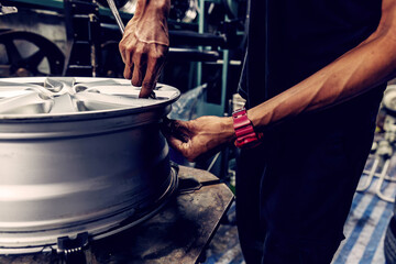 Mechanic removing a tire from the rim after using a tire bead breaker at  shop. workers remove the tire from the rim with a tire-removing machine device,Mechanic repairing tire.