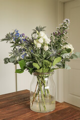 Flowers in vase on a table with colorful flower arrangement.