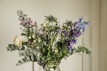 Flowers in vase on a table with colorful flower arrangement.