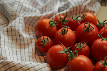 Tomatoes stacked on top of each other on a tea towel, tomato texture.