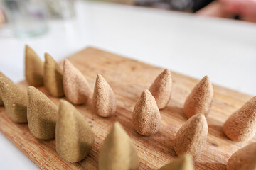 Manual process of making incense cones.