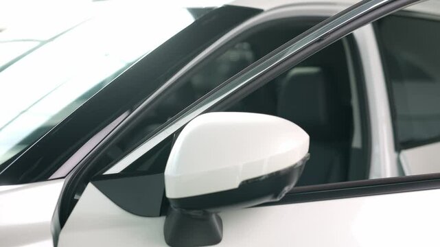 A young woman settles into a modern car, embodying contemporary automotive technology and comfort. This vehicle promises a seamless driving experience, blending style and innovation for every journey.