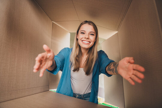 Photo of customer young blonde hair funny girl in blue shirt unpacking received arrived parcel delivery goods carton shopping package