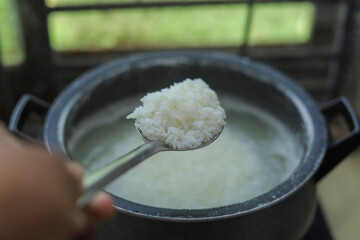 White Rice Cooking With Spoon Close up photo