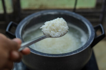 White Rice Cooking With Spoon Close up photo