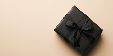 Elegant black gift box with ribbon, ideal for Christmas, birthdays, Black Friday, stylish present concept