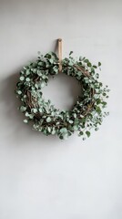 Minimalist Eucalyptus Wreath on White Wall - Natural Decor with Greenery and Rustic Charm