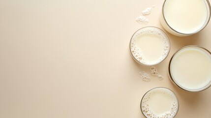 Fresh Goat Milk in Glasses on Beige Background