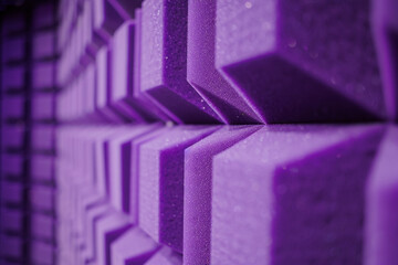 Close perspective of a corner covered in lilac acoustic foam highlighting the acoustical engineering of a music studio