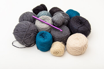Balls of wool yarn and crochet hook. Crochet socks, mittens or clothes