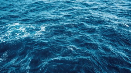 Obraz premium A close-up view of the vast blue ocean with gentle waves and whitecaps.
