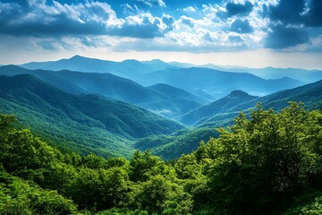 Obraz premium Aerial View of Mountain Range with Lush Greenery and Dramatic Clouds