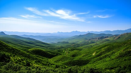 Naklejka premium A serene mountain landscape with lush green valleys and a clear blue sky, capturing the essence of tranquility