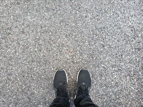 Foot and legs seen from above. top view of feet standing on ground - Powered by Adobe