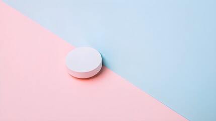 A minimalist composition featuring a single lens cap on a soft pastel backdrop, emphasizing simplicity in photography