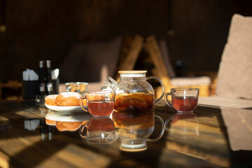 Tea with donuts on table. Delicious food in summer. Details of table in restaurant.