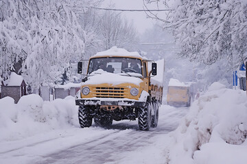 A snow plow clearing the streets, showcasing winter road maintenance and efficient snow removal.