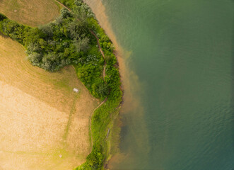 A view of a lake with a path running along the shore