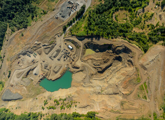 A large open pit mine with a large body of water in the middle