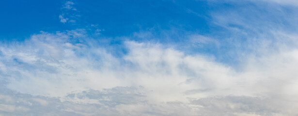 white clouds of uncertain shape in the blue sky sunny day