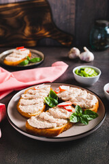 Crab stick and cucumber pate on toast on a plate on the table vertical view