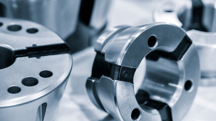 A collection of metal parts with a silver color. The parts are arranged in a way that they look...