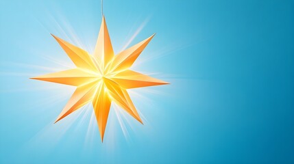 Obraz premium a stylized, bright, golden star with eight points. It is set against a clear blue background. The star appears to be glowing, with light radiating from its center, giving it a luminous and vibrant app