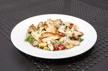 Caesar Salad, Green Lettuce Salat with Chicken and Parmesan Cheese Closeup