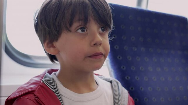 Young boy enjoying a pretzel snack on a train, candid moment of childhood joy and exploration during travel, highlighting the simple pleasures of a young adventurer's journey