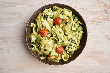 Penne rigatte with blue cheese sauce and tomatoes