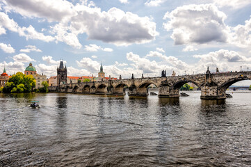 Fototapeta premium Prague, Czech Republic - July 19, 2024: Morning views along the Vltava River and Charles Bridge n Prague in the Czech Republic 
