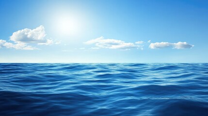Obraz premium A vast expanse of blue ocean water under a bright, sunny sky with fluffy white clouds.