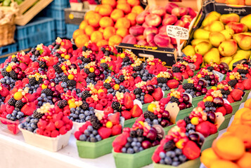 Prague, Czech Republic - July 16, 2024: Fruits and berries for sale at a market vendor on the streets in Prague in the Czech Republic
