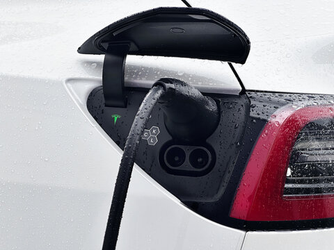 Karben, Germany- 25. Septmeber 2024. Tesla EV electric vehicle charging during rain